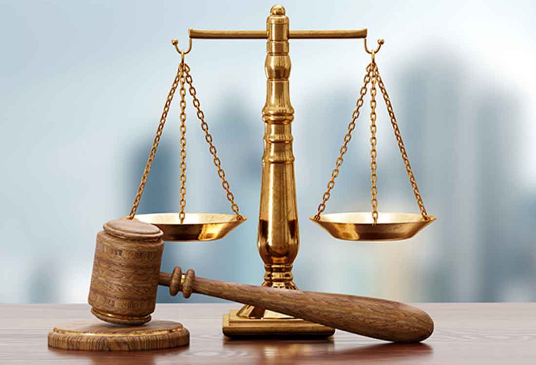 Golden justice scales with wooden gavel