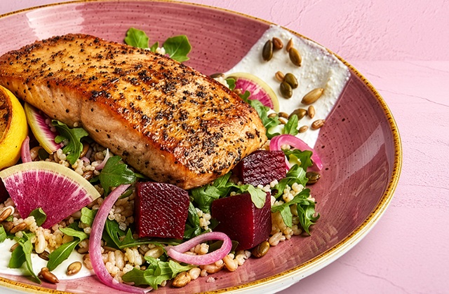 a plate of food on a pink surface