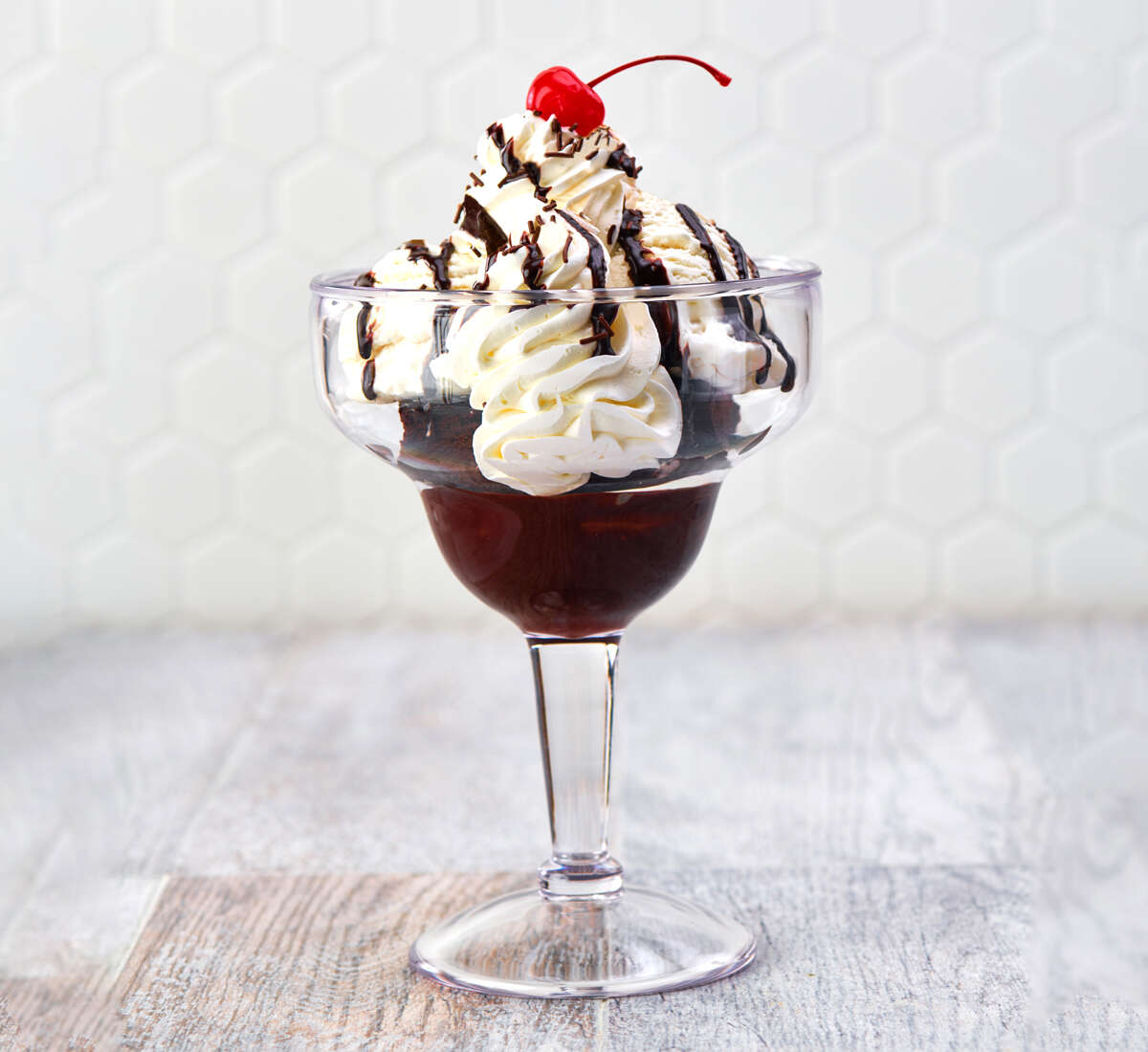 Hot Fudge Brownie a glass with ice cream and chocolate syrup