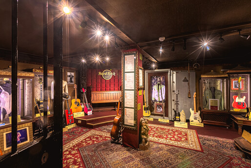 a room with guitars and a red rug
