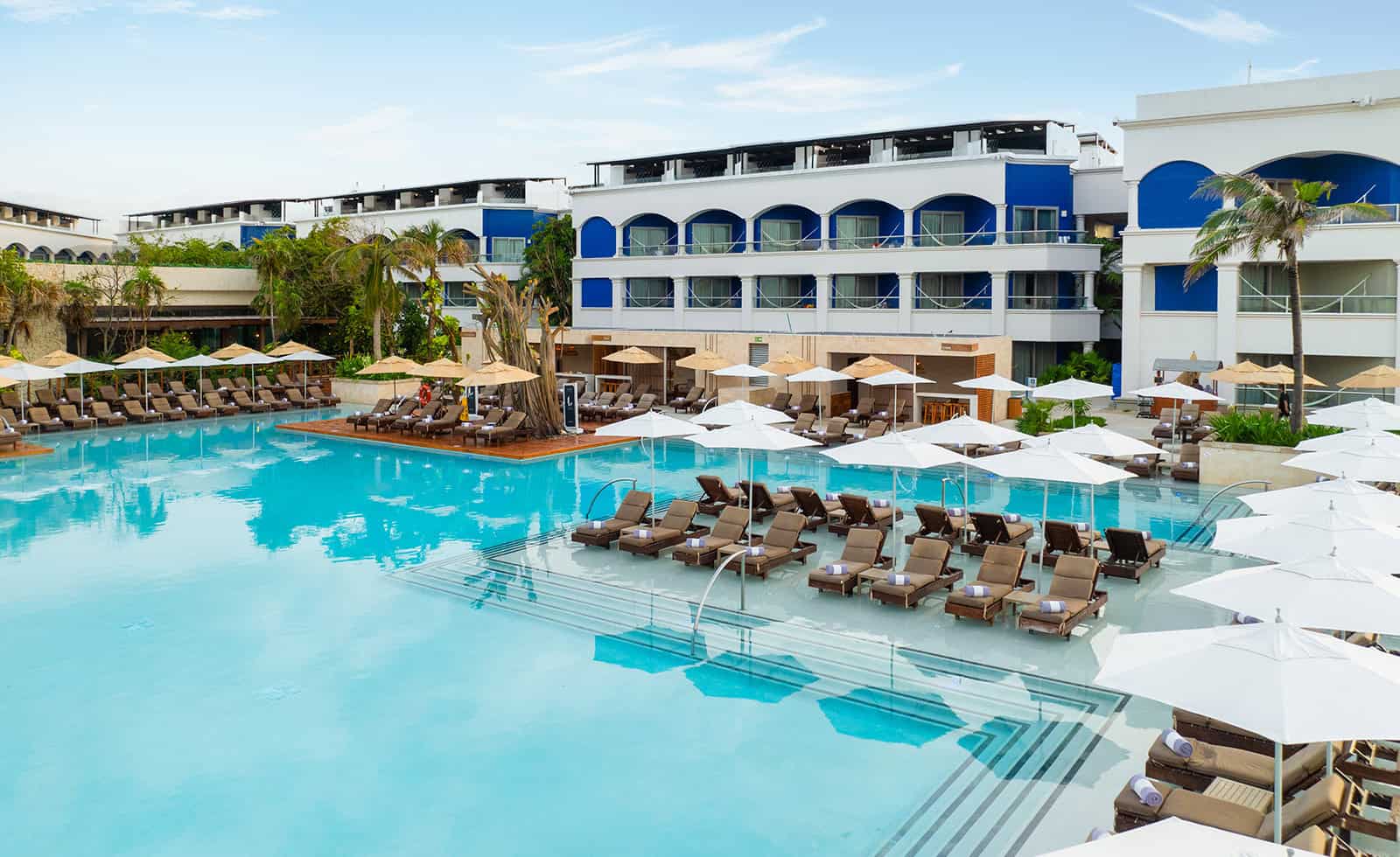a pool with umbrellas and chairs